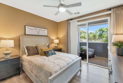 a bedroom with a bed and a ceiling fanat Weylyn Luxury Apartments, Laveen, AZ 85339