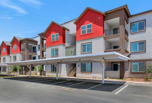 an empty parking lot in front of a row of apartment buildings at Weylyn Luxury Apartments, Arizona