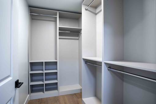 A white closet with shelves and drawers at The Laurel Apartments, Chandler, AZ  .