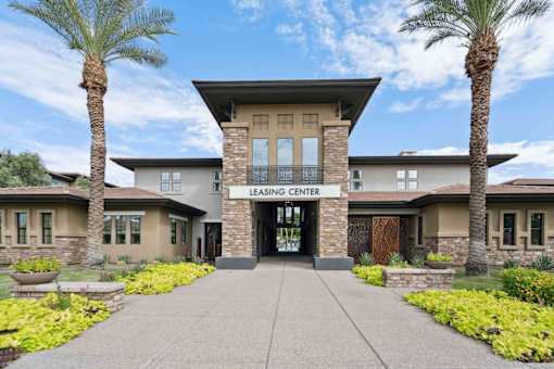 A building with a leasing center sign in front of it. at The Laurel Apartments, Chandler, AZ 85286  
