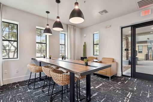 A conference room with a long table and chairs. at The Laurel Apartments, Chandler Arizona  