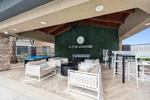A patio with a pool table and chairs is labeled  at The Laurel Apartments, Arizona  