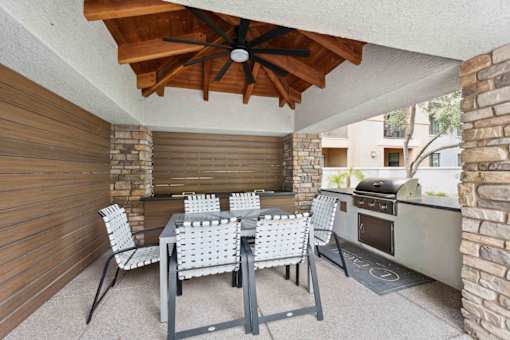 A patio with a table and chairs and a grill. at The Laurel Apartments, Chandler, AZ 85286  