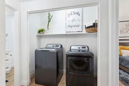Two black front load washing machines in a laundry room. at The Laurel Apartments, Chandler, 85286  