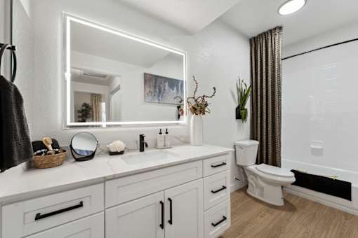 A bathroom with a white countertop and a white toilet at The Laurel Apartments, Chandler, AZ 85286  .