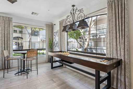 A dining room with a wooden table and chairs. at Lazo Apartment Homes, Chandler, AZ 85225  