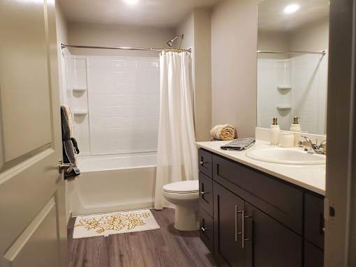Modern bathroom with white countertop and dark cabinets at Pinon Lofts Apartments, Sedona, Arizona
