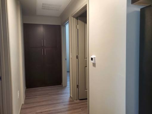 Hallway with wood flooring and builtin storage at Pinon Lofts Apartments, Arizona, 86336