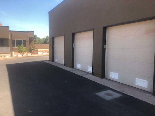 Three car garage doors with individual access at Pinon Lofts Apartments, Sedona, AZ 86336