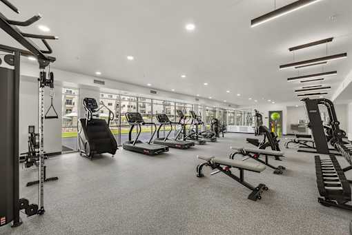 Spacious gym with cardio and strength training machines at Lucero Apartments, Phoenix, AZ