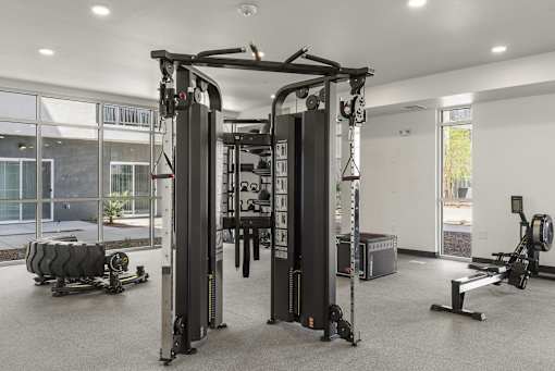 Fitness center with cable machine and rowing equipment at Lucero Apartments, Phoenix, 85051