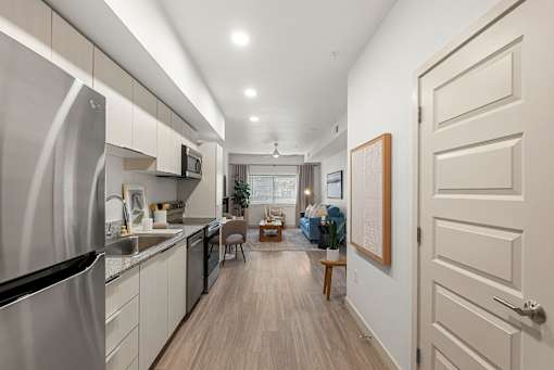 Open layout kitchen with stainless steel appliances at Lucero Apartments, Phoenix, 85051