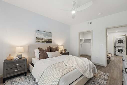 Bedroom with walk-in closet and laundry access at Lucero Apartments, Phoenix, Arizona