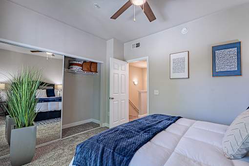 A bedroom with a bed, a ceiling fan, and a potted plant.at Palazzo Townhomes, Phoenix, 85008  