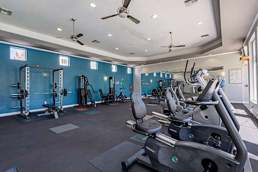 A gym with a row of treadmills and exercise equipment.at Palazzo Townhomes, Phoenix Arizona  