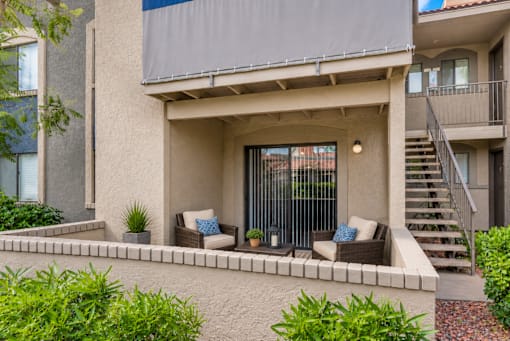 A modern house with a patio and a staircase.