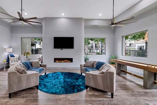 A living room with a television, two couches, and a rug.