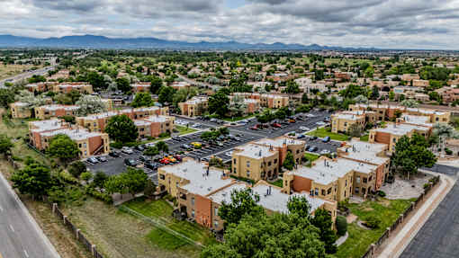 A view of a town with buildings and cars from a high vantage point.