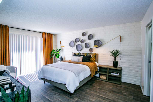 a bedroom with a bed and a white brick wall