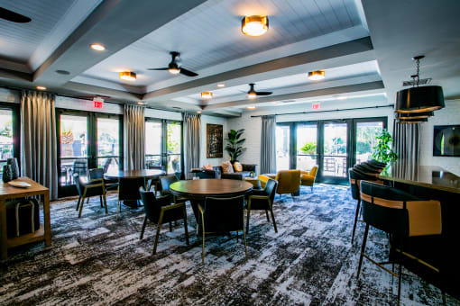 a large room with tables and chairs and a television