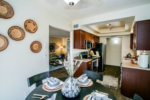 the view of the dining room and kitchen from the living room with the dining table