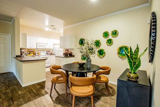 A kitchen with a table and chairs in the middle of the room.