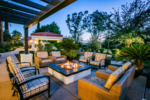 a patio with furniture and a fire pit