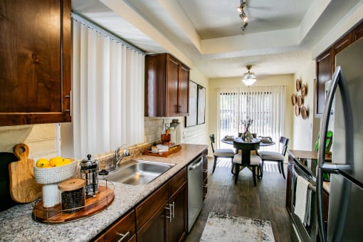 kitchen with stainless steel appliances and granite counter tops and a dining room with a table