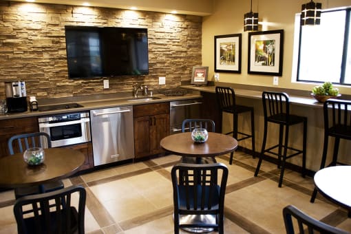 Clubhouse with Stools and Appliances at River Walk Apartments NM