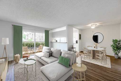 A modern living room with a grey sofa and a round mirror on the wall.