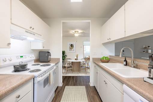 1-Bedroom Apartments in Goleta, CA - Pacific Oaks - Kitchen With Electric Stove, Sink, and Countertops, Upper And Lower Cabinets.