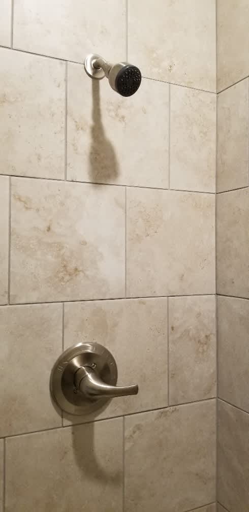 A shower head mounted on a wall.