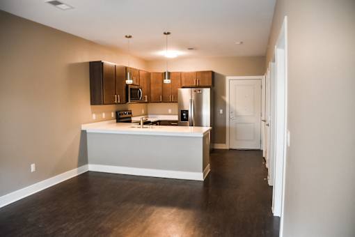 A kitchen with brown cabinets and a white island.