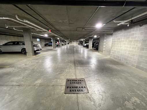 A parking garage with a sign that says "PENOBAMA STATE" on the floor.