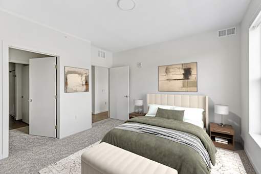 A bedroom with a large bed and a painting on the wall.