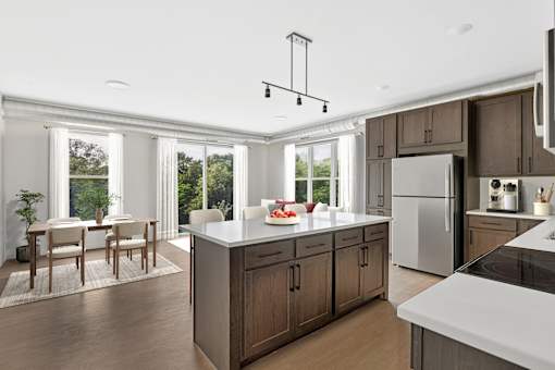 A kitchen with a table and chairs in front of a window.