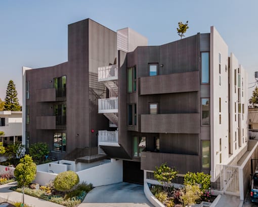 A modern building with a curved design and balconies.