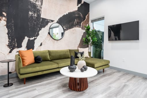 a living room with a geometric tile floor and a green couch at Lido Apartments - 4025 Grandview, Culver City, California