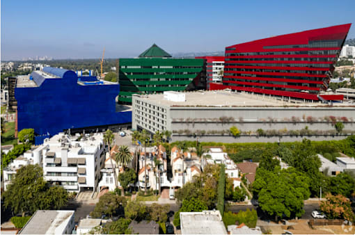 A cityscape with buildings in blue, green and red.