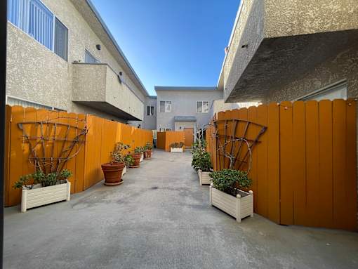 A courtyard with orange fences and potted plants at 3615 Watseka Ave, Los Angeles, CA, 90034