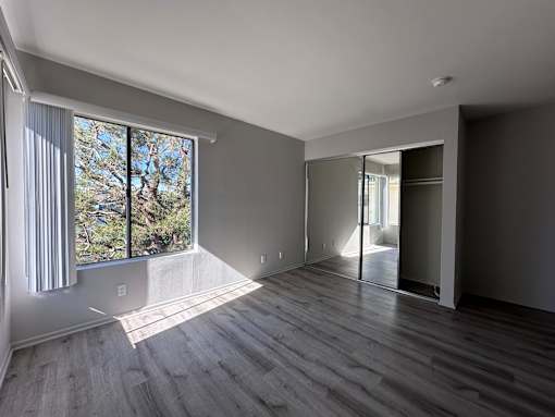 A room with a large window and sliding glass doors at Lido Apartments - 3130 Bagley Ave, Los Angeles, 90034