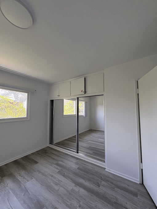 A room with a grey floor and white walls.