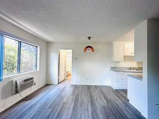 A room with a grey floor and a white ceiling.