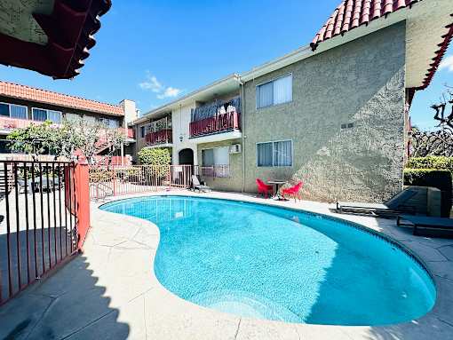 A pool in a courtyard surrounded by buildings.