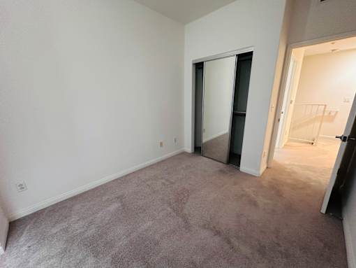 Empty room with soft carpeted floor at Lido Apartments - 10133 Tabor St, Los Angeles, California