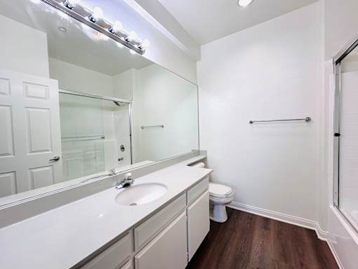 Modern bathroom with mirror and sink at Lido Apartments - 10133 Tabor St, Los Angeles, CA, 90034
