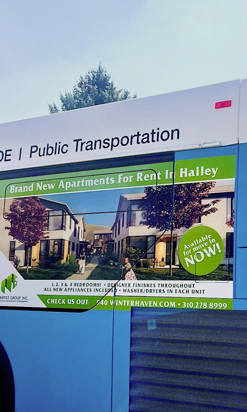 a sign on the side of a blue bus
