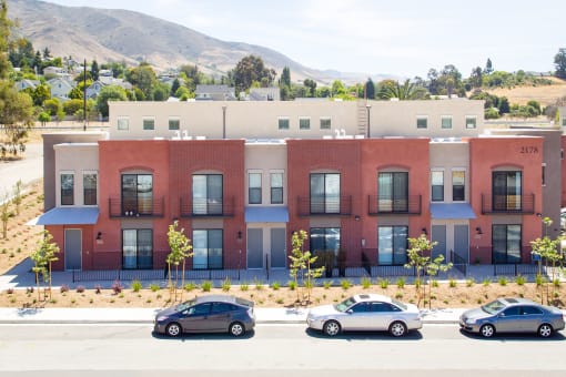 a red brick building with cars parked in front of it  at Roundhouse Place, San Luis Obispo, California