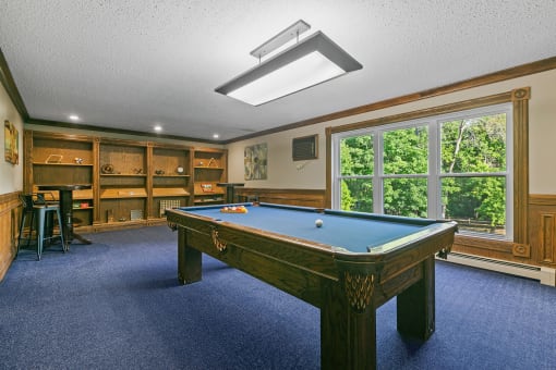 a game room with a pool table and a bar