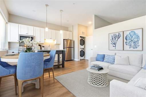 A modern kitchen with a dining table and chairs.
